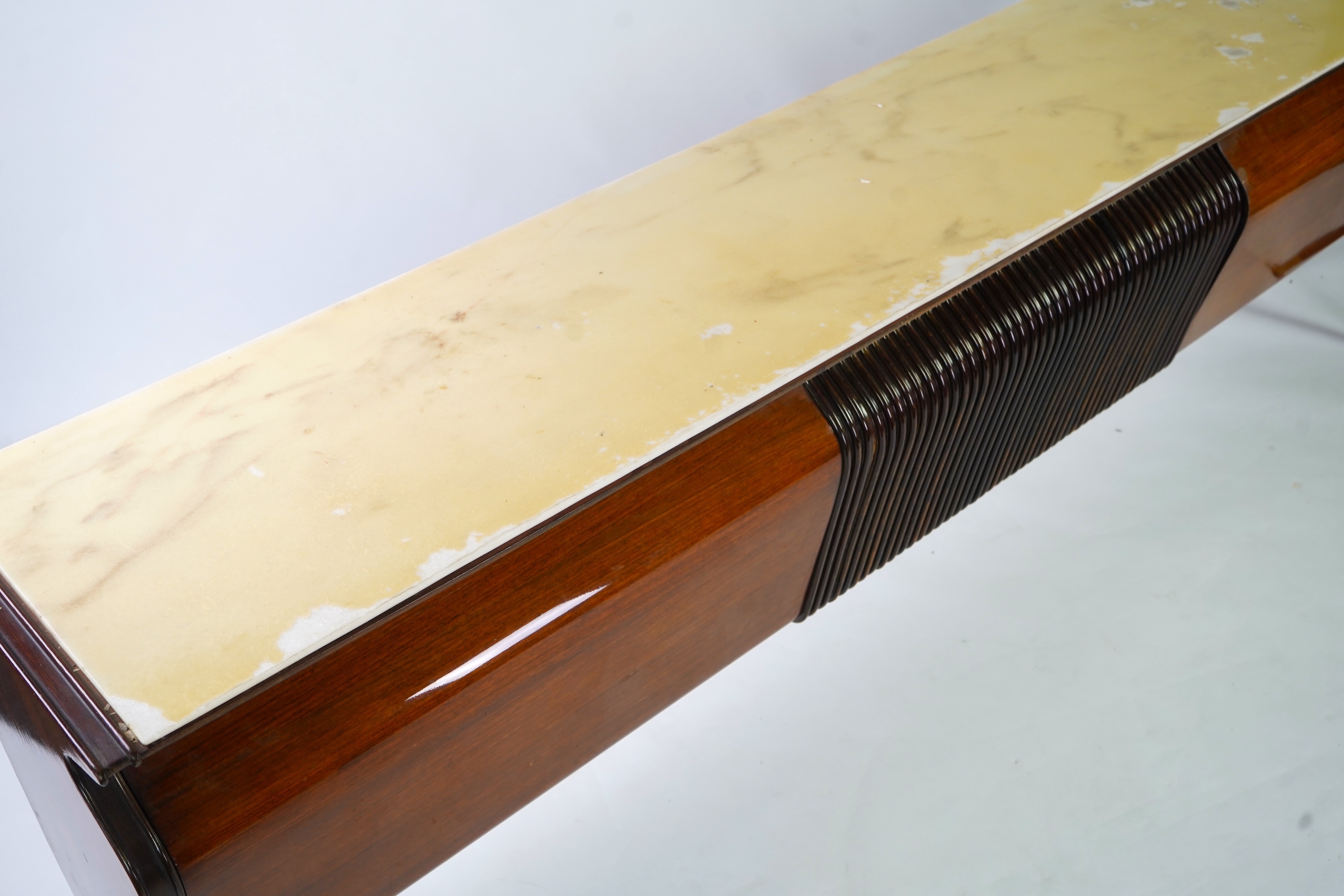 Osvaldo Borsani (Italian, 1911-1985) for Atelier Borsani Varedo: A large Indian rosewood and mahogany credenza, 276.5cm wide x 49cm deep x 94cm high